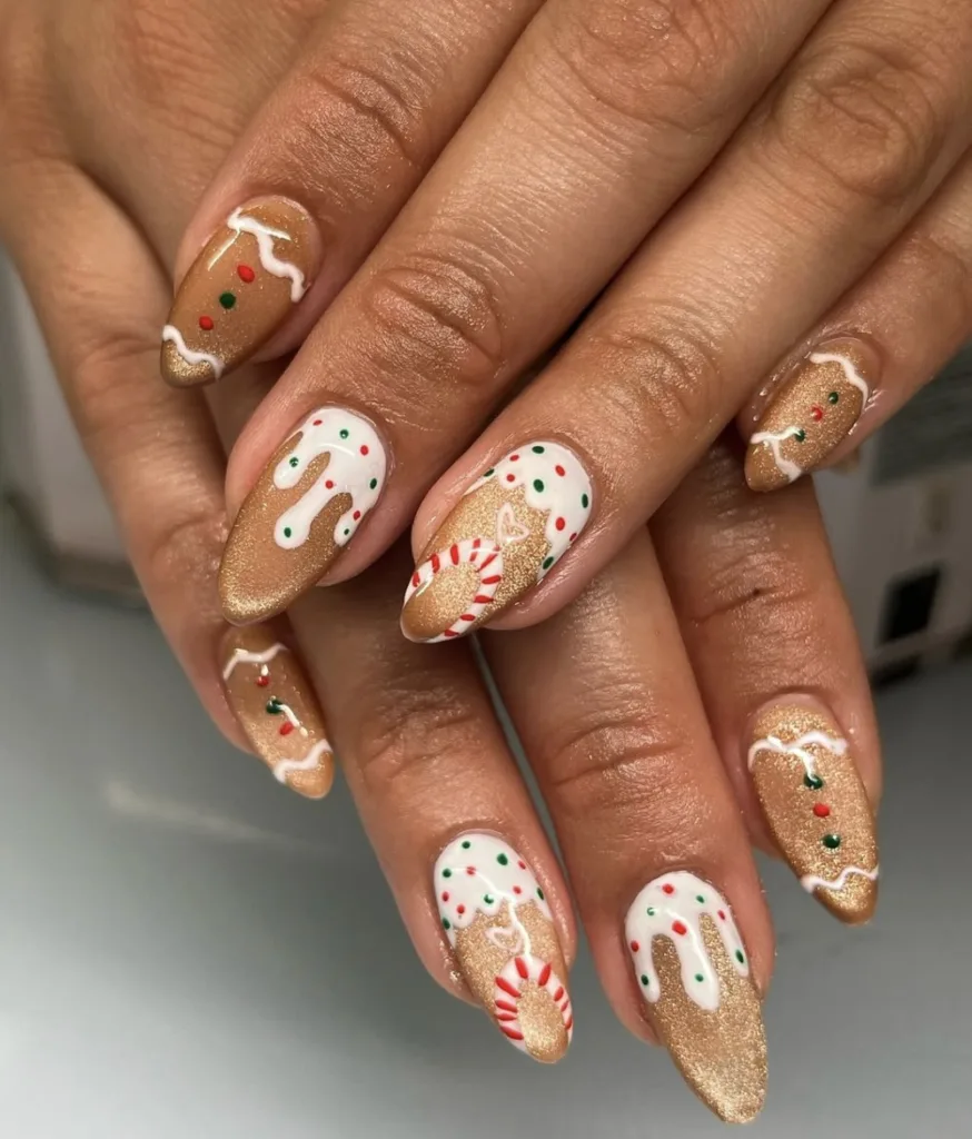 gingerbread christmas nails with white icing drips candy accents and golden shimmer