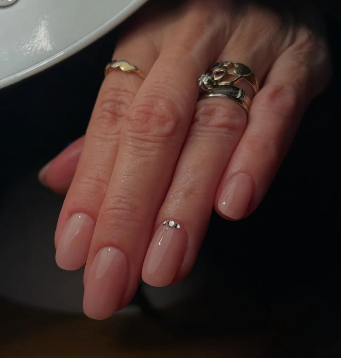 nude oval glossy rhinestone nails