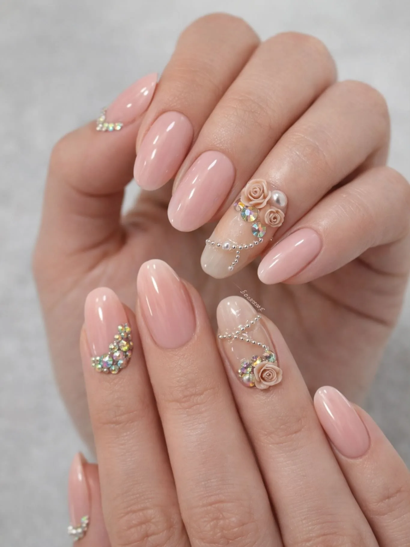 peachy pink almond embellished nails