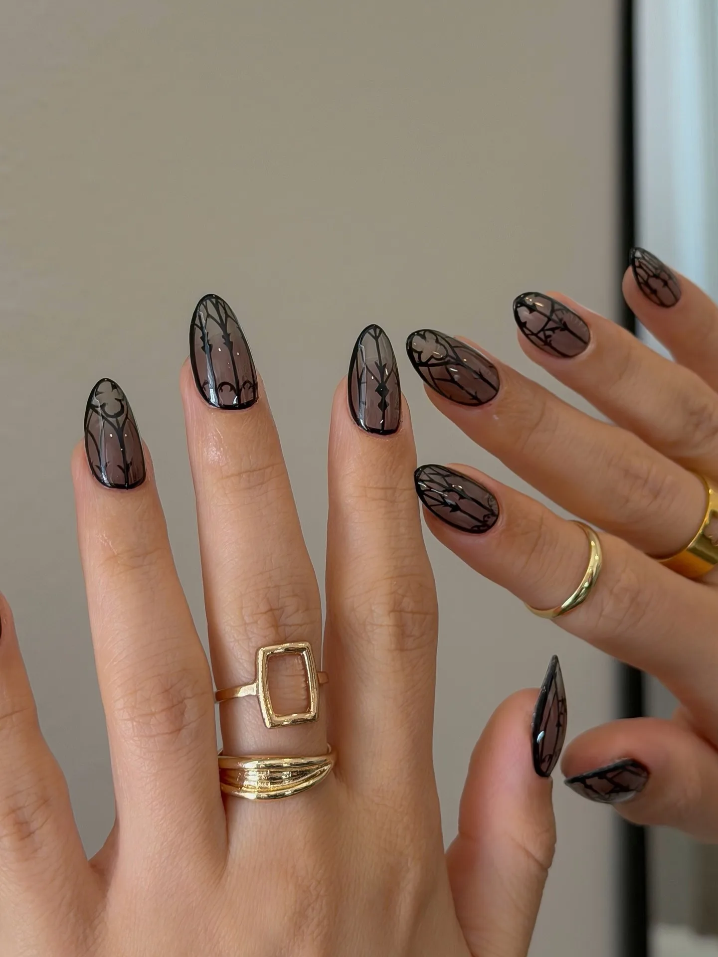 smoky brown almond geometric nails