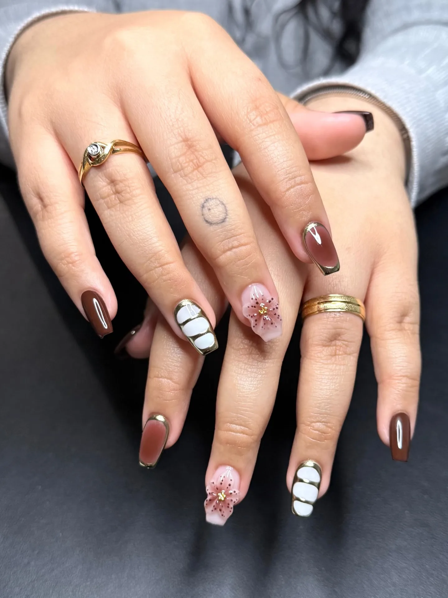 brown almond mixed design nails