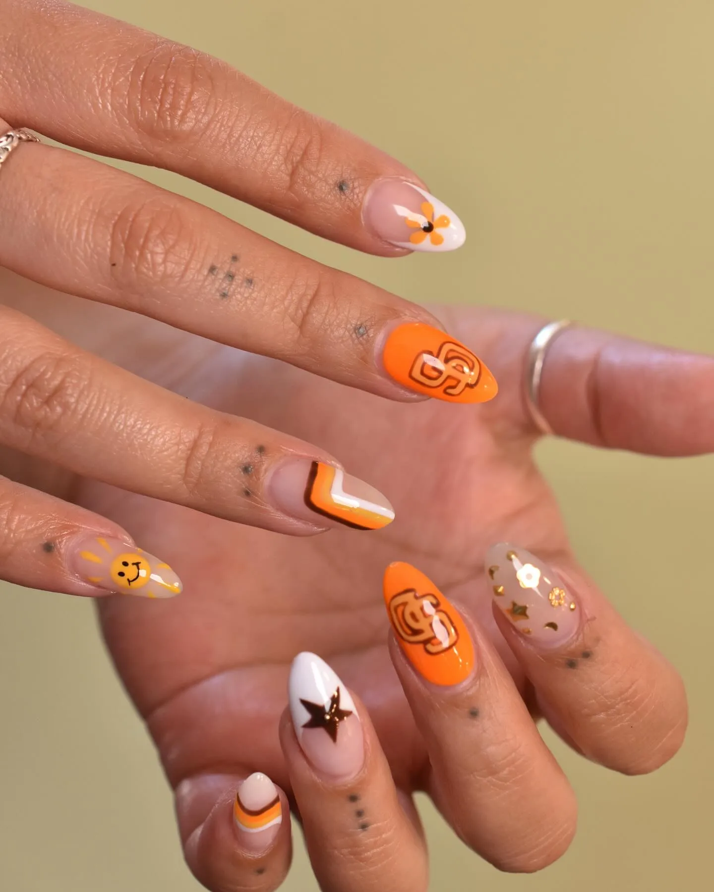 clear orange almond decorated nails