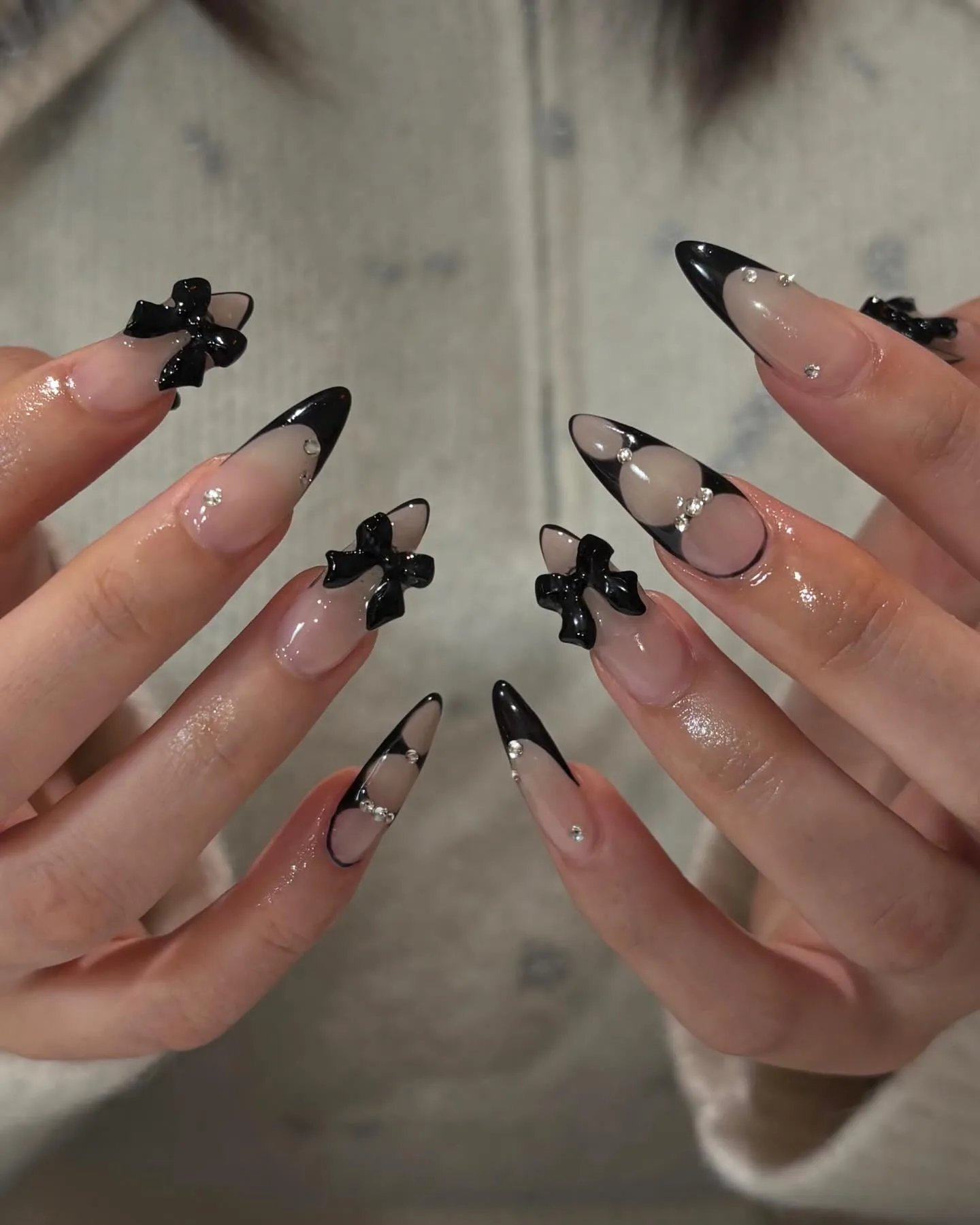nude stiletto black french bow nails