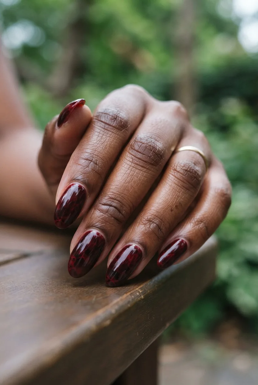 oxblood oval glossy marble nails