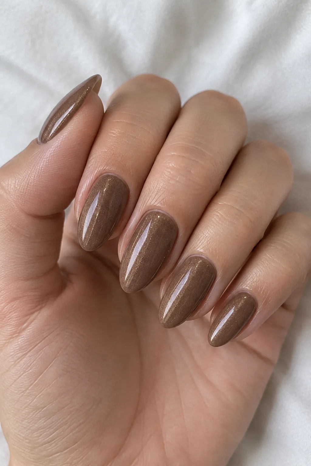 Cocoa almond nails dusted with shimmering champagne pearl powder