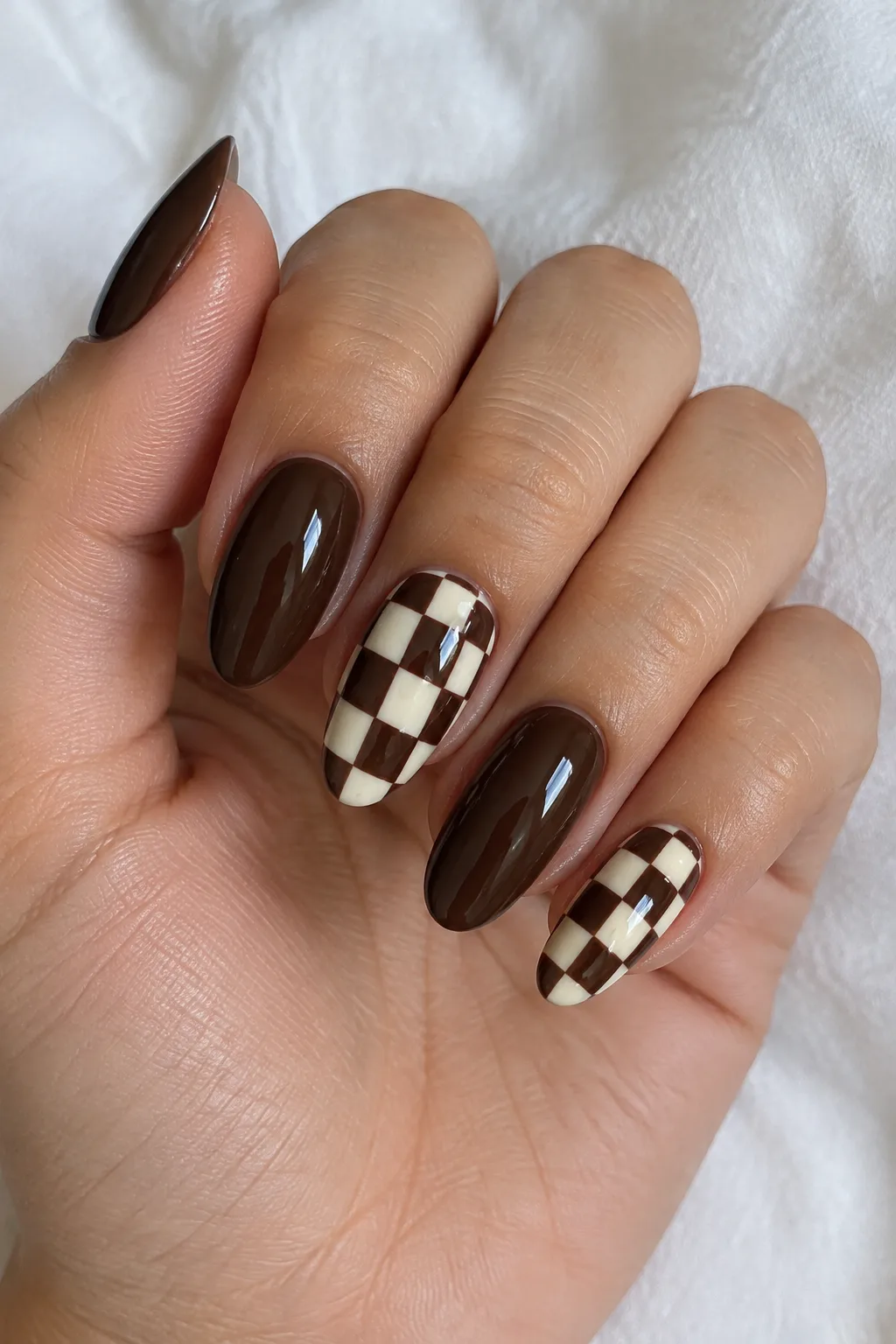 Chocolate and cream checkerboard pattern on an accent almond nail