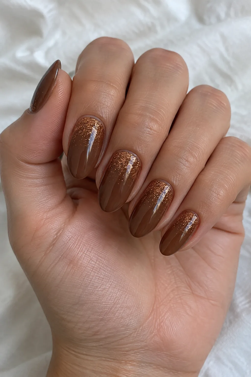 Hot cocoa brown almond nails with a copper cinnamon glitter gradient