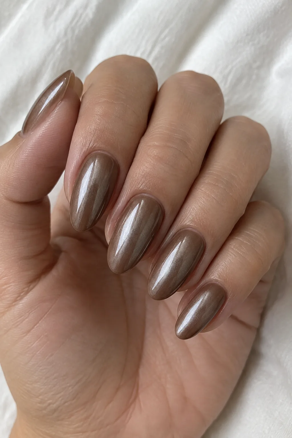 Mocha chrome almond nails with a pearly glazed donut-shine effect