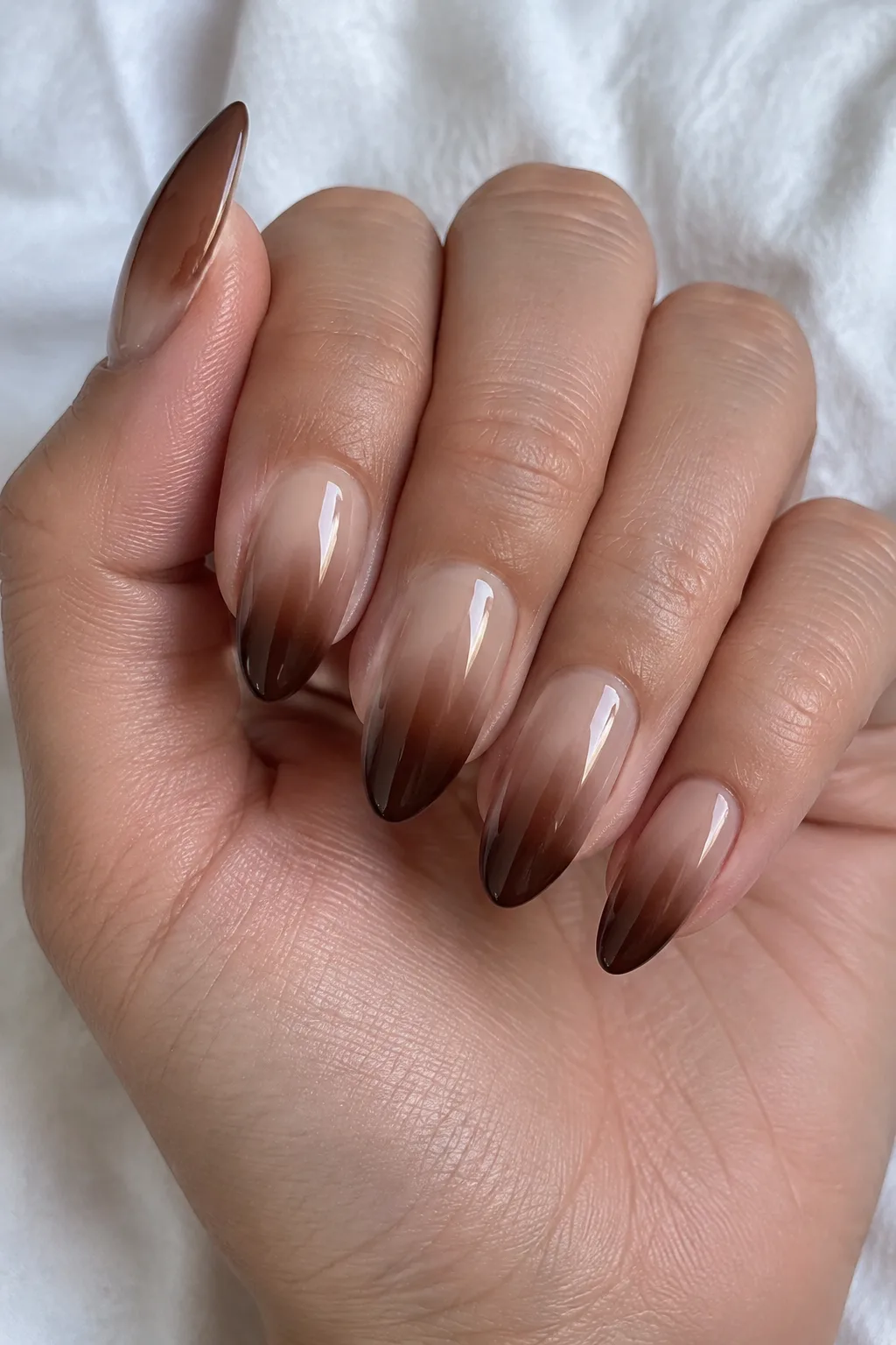 Almond nails with an ombre fade from milky latte to dark chocolate brown