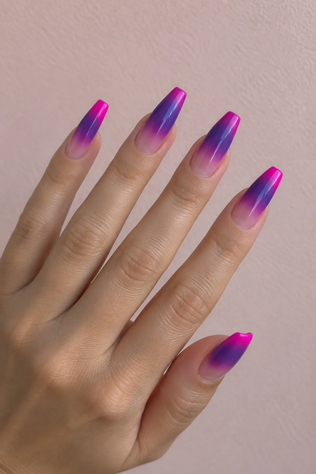 Magenta to violet faded French tips on long coffin nails with an ombre blend