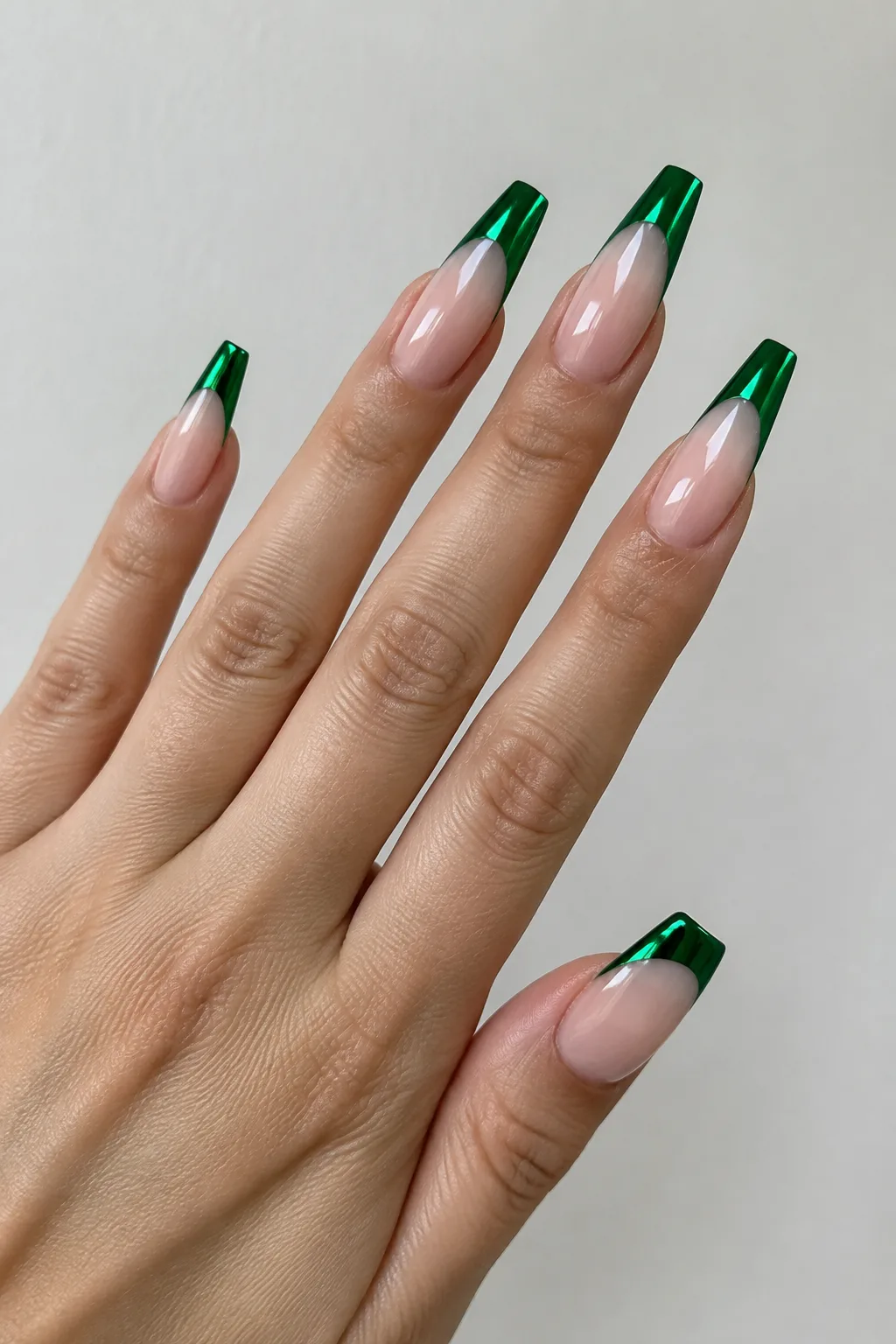 Emerald green chrome French tips on ballerina coffin nails with a metallic shine