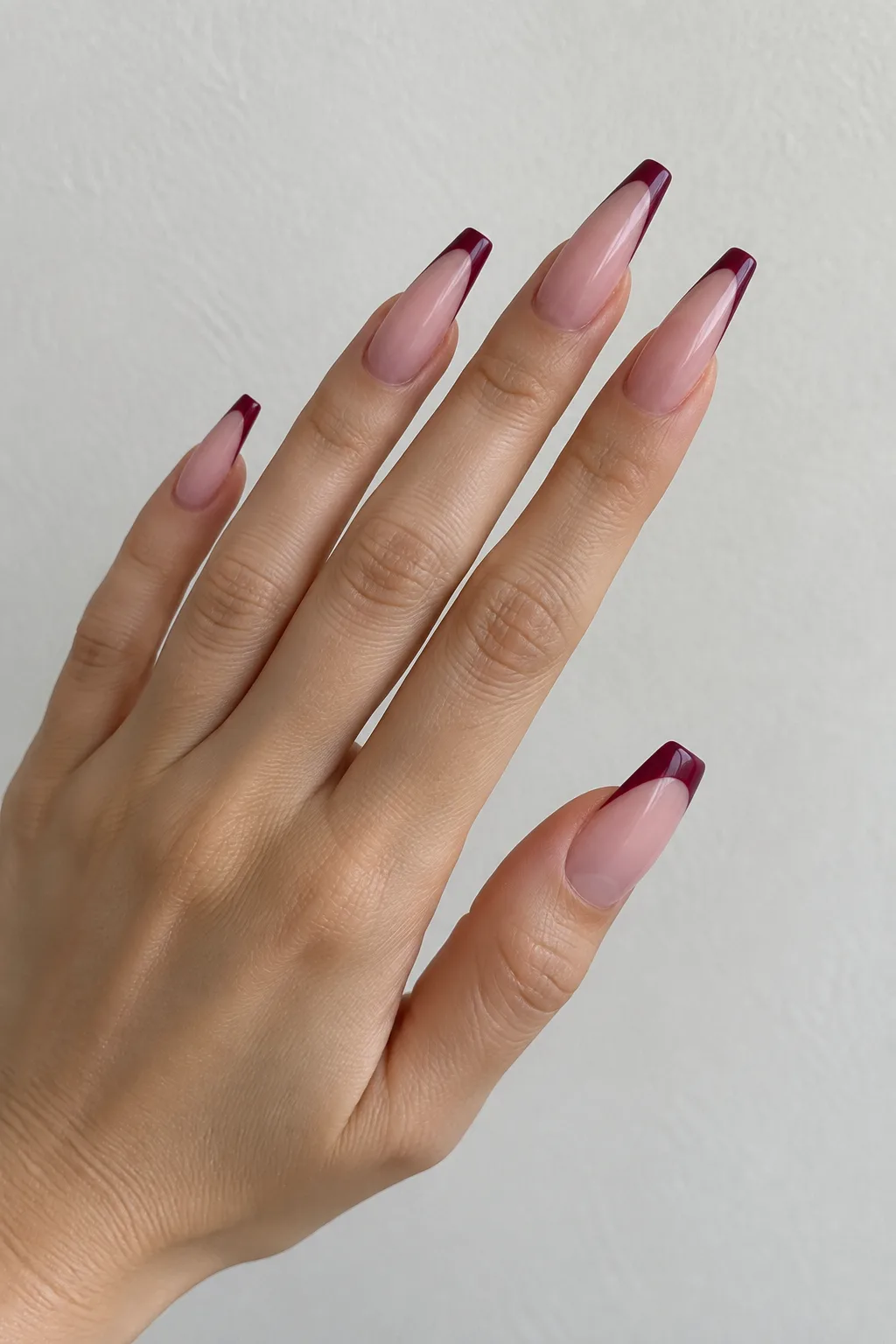 Mulberry wine polish framing classic white french tips on medium square nails