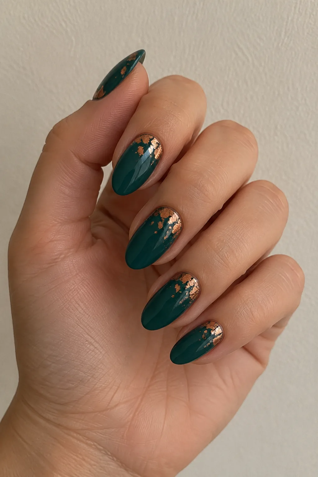 Deep teal polish with crinkled copper foil accents on two accent nails