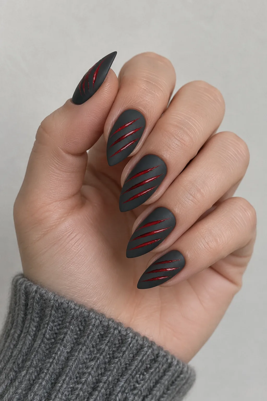 Charcoal and crimson nails with a clawed werewolf slash design