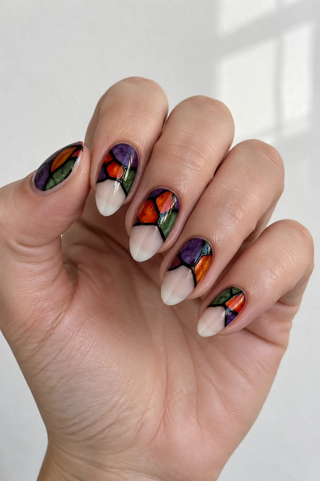 Jewel-toned nails with gothic stained glass window inspired patterns