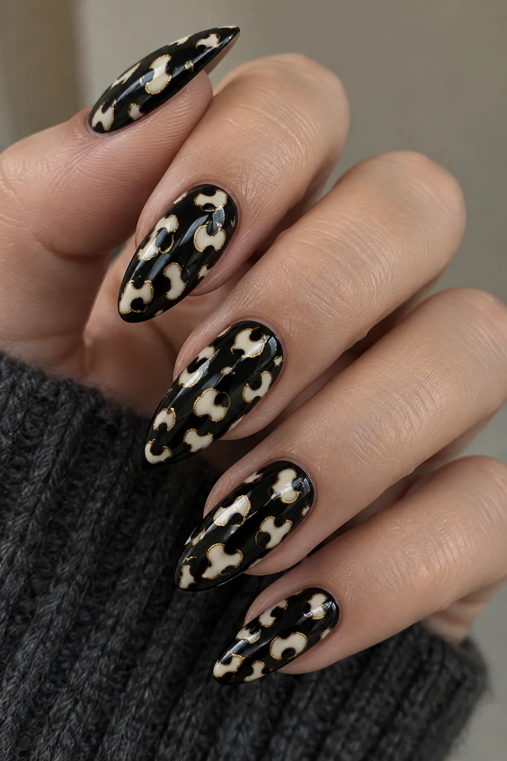 Black base leopard print nails for autumn with cream spots and gold outlines