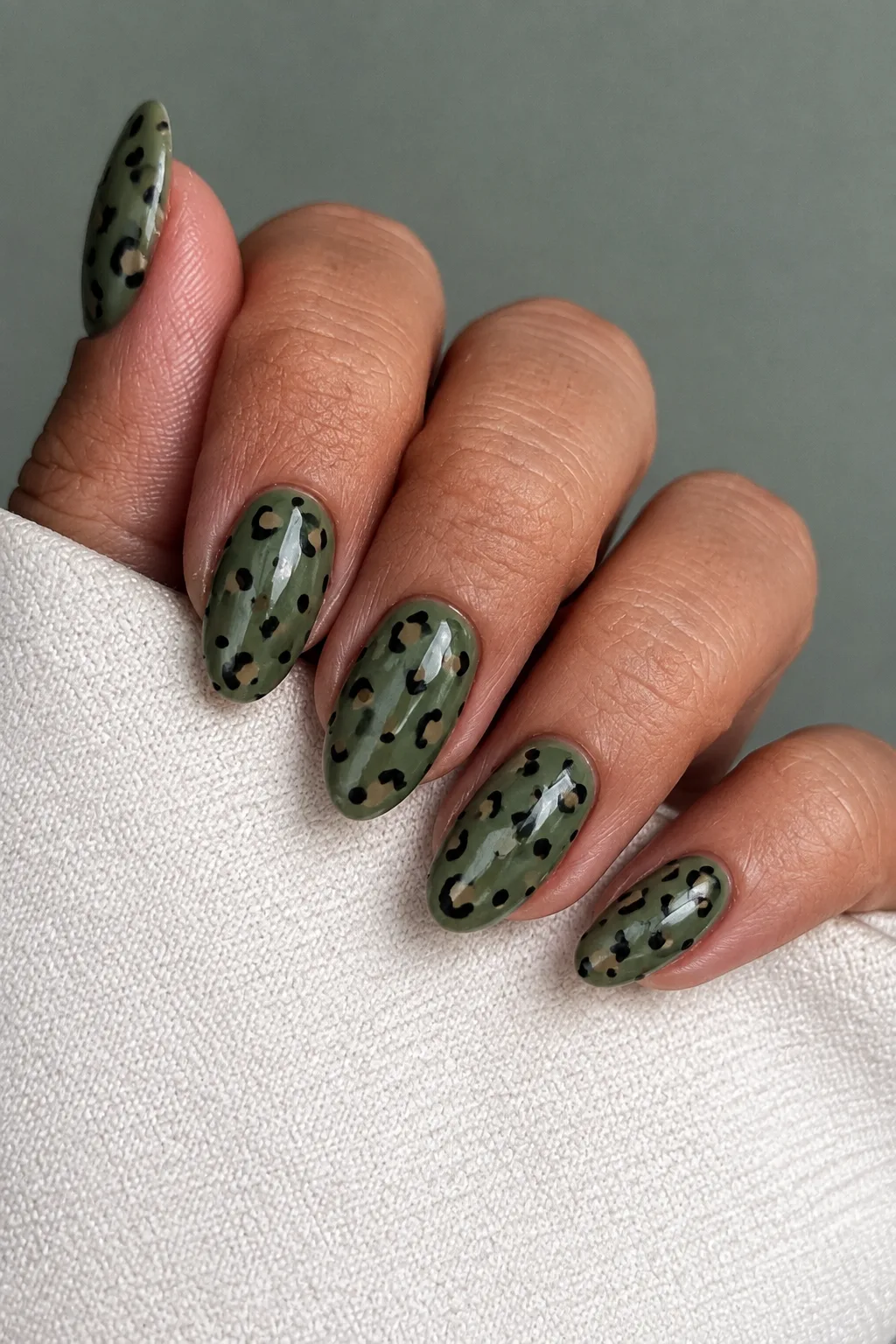 Olive green leopard print nails for autumn with khaki and black spots