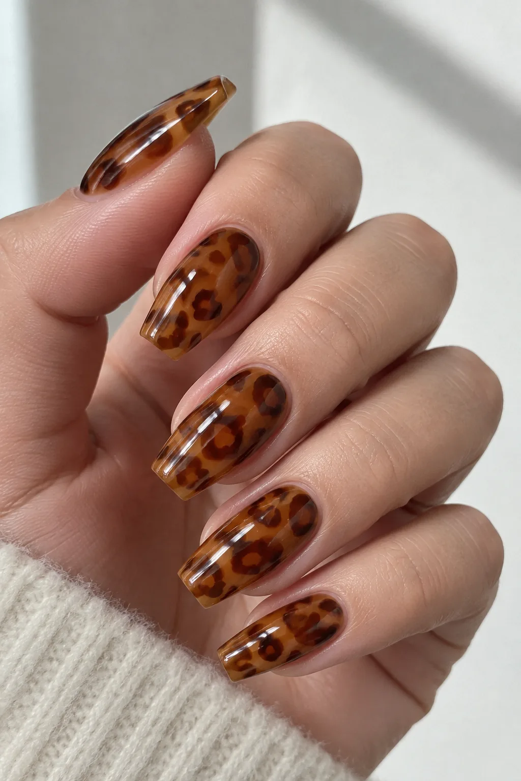Amber jelly leopard print nails for autumn on medium coffin nails