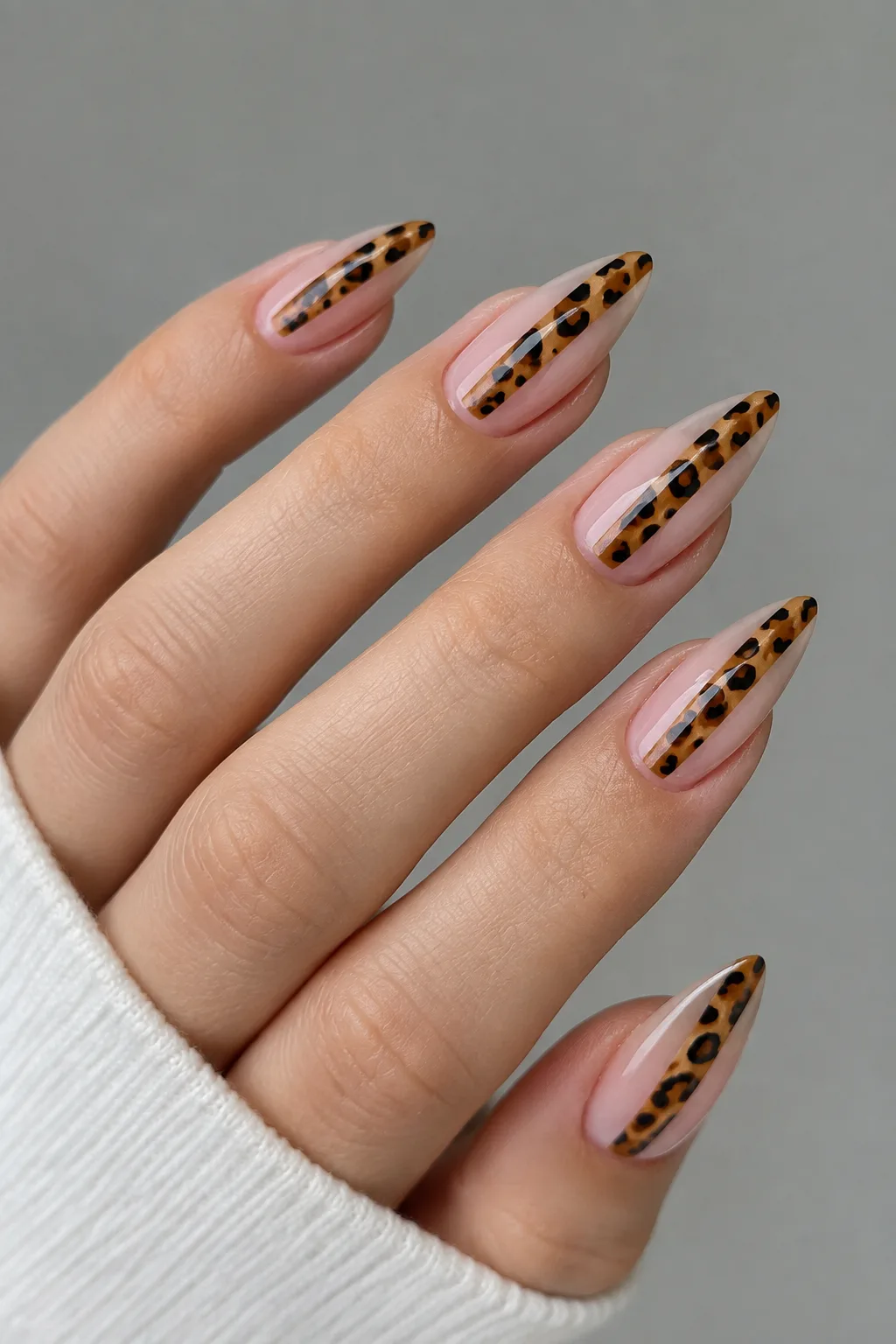 Negative space leopard print nails for autumn with a center stripe