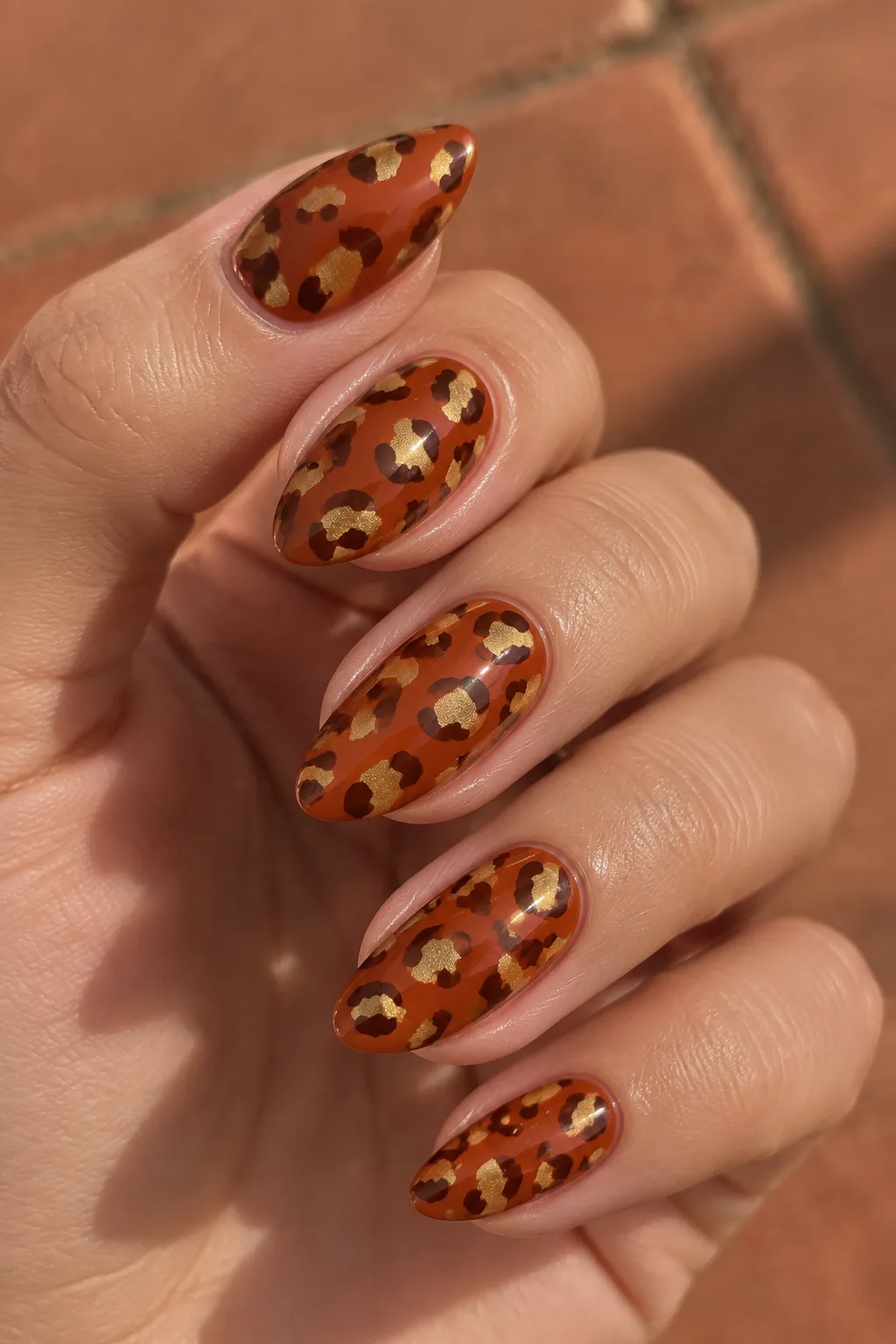Rust orange and gold leopard print nails for autumn