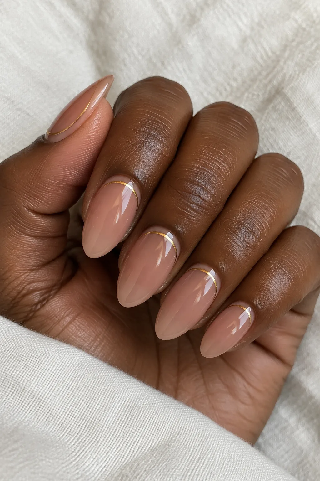 Sheer toffee nude nails with a thin gold line traced along the cuticle