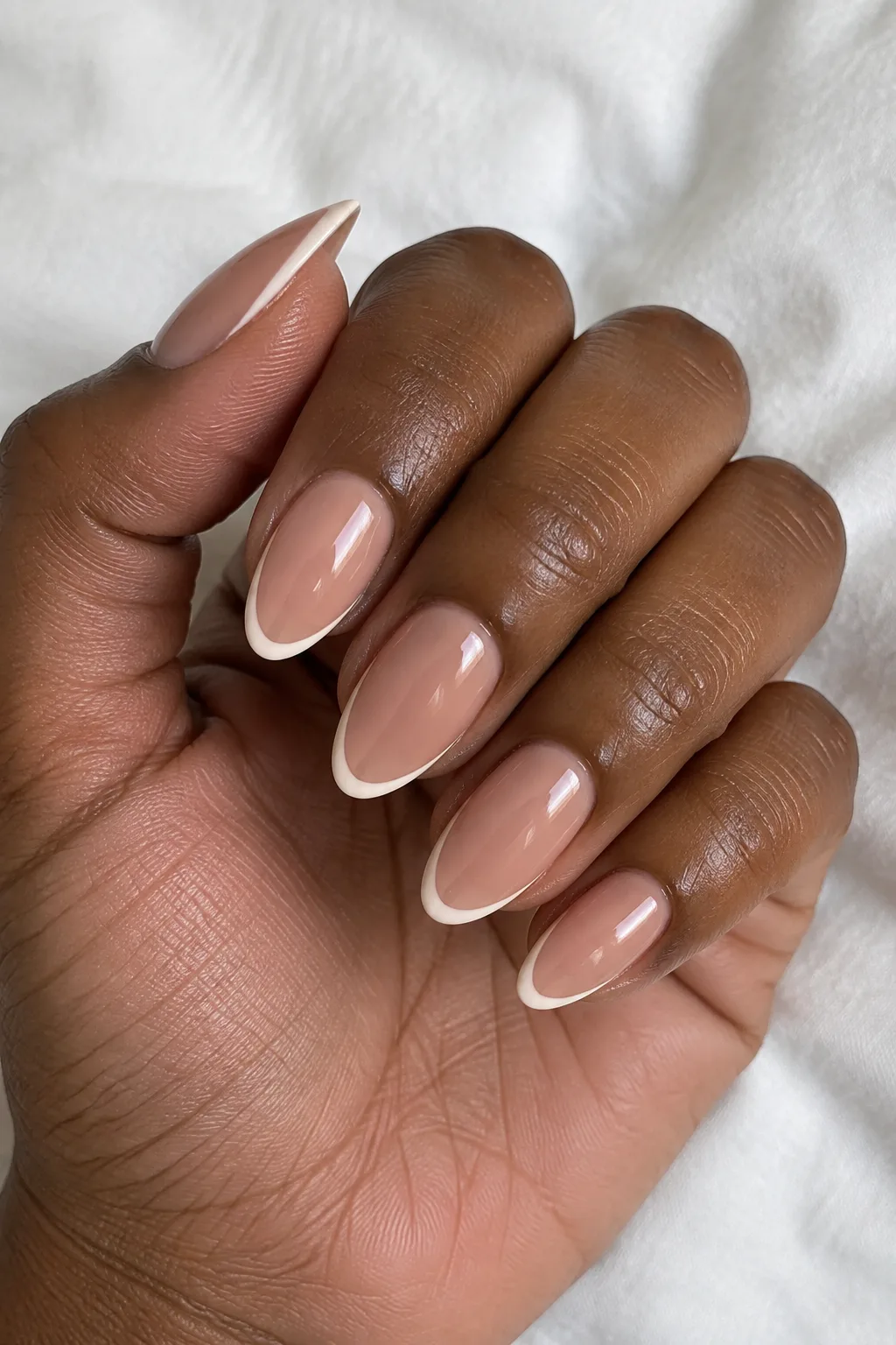 Clay nude nails with cream tips outlined in a thin contrasting line