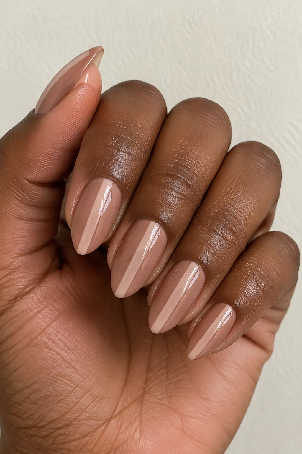Negative space toffee nude nails with a bare center stripe design