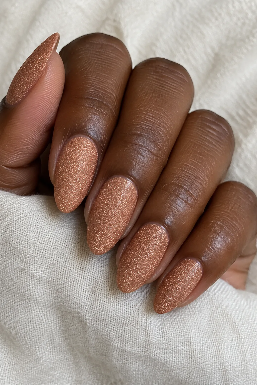 Copper sand polish with a textured sugar finish on natural nails