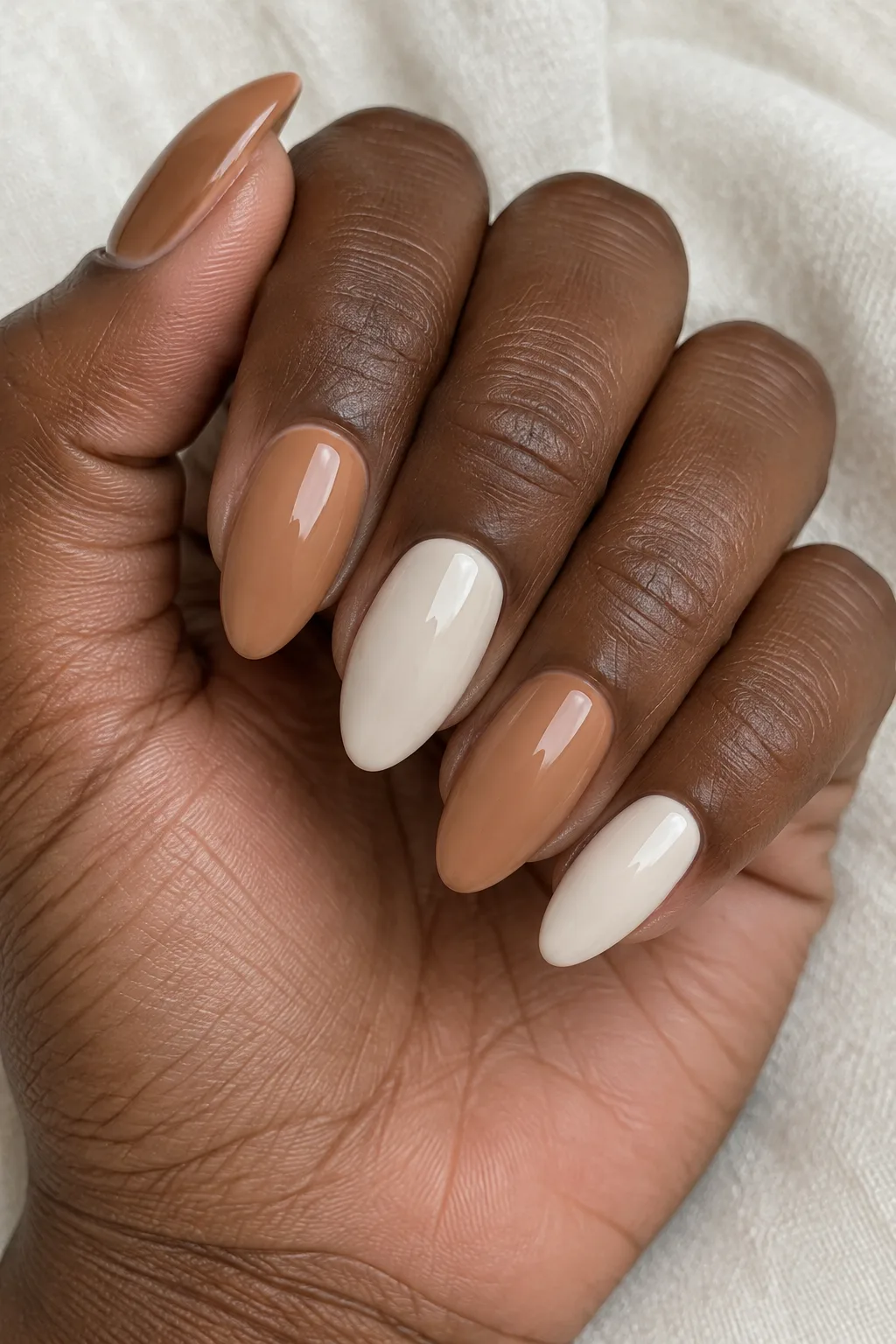 Two-tone manicure combining caramel and cream shades on each nail