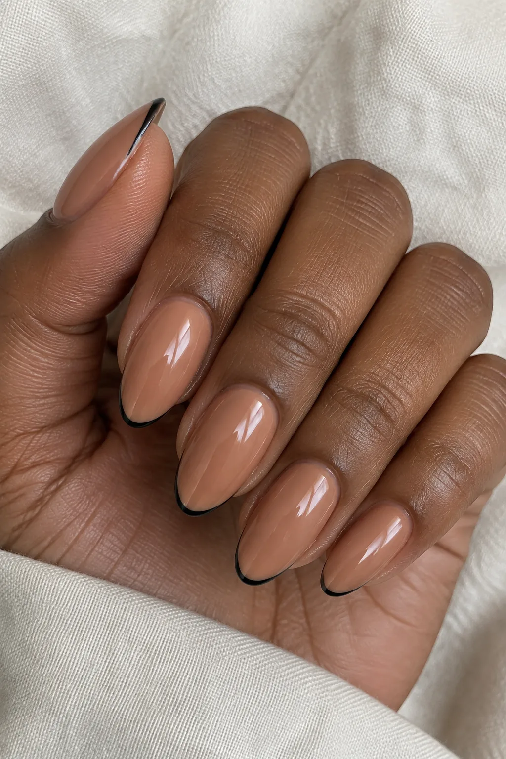 Cinnamon brown nails lined with thin black micro tip outlines