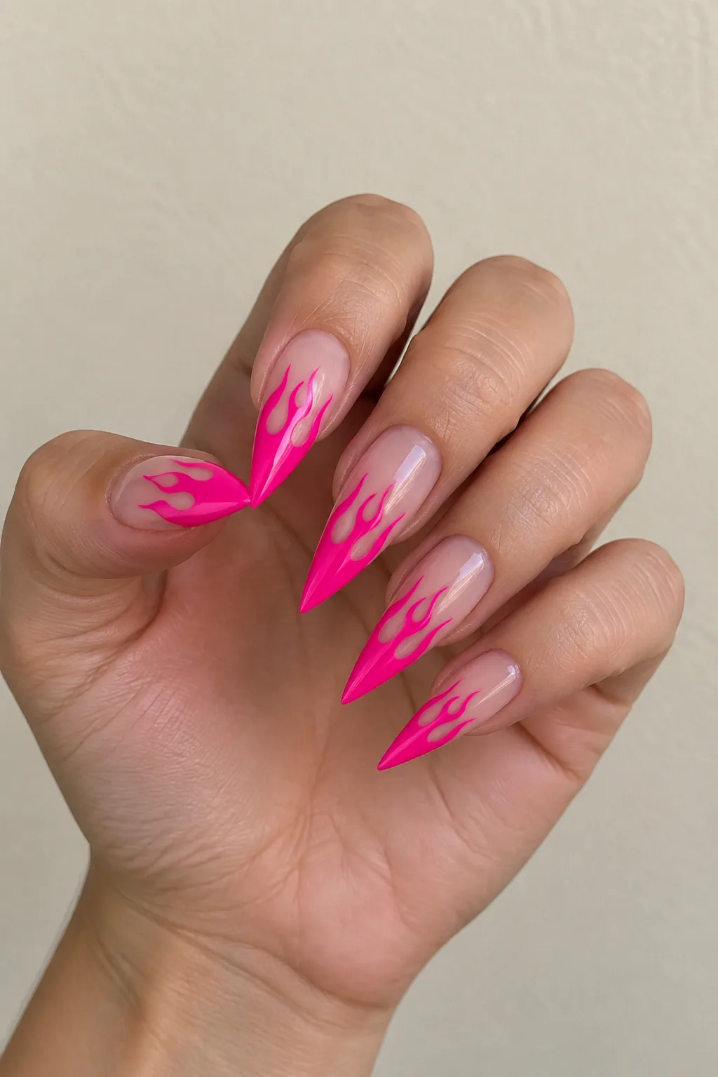 Hot pink flame-shaped French tips on medium almond nails