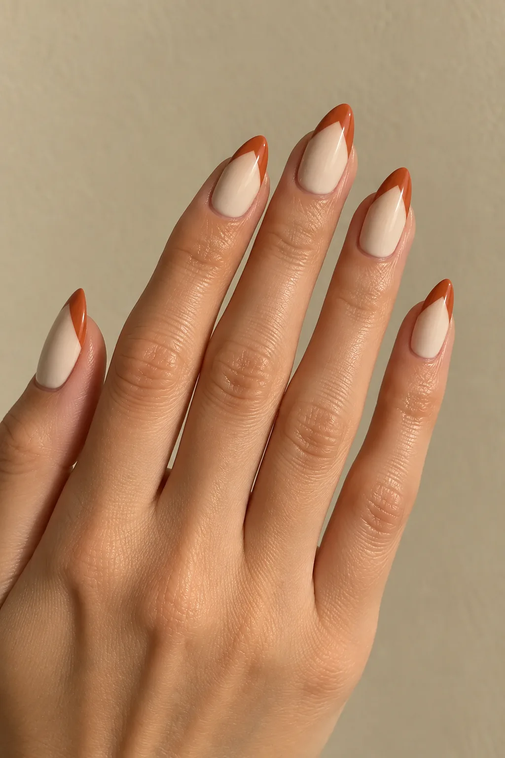 Terracotta deep V French tips on long almond nails with a matte finish