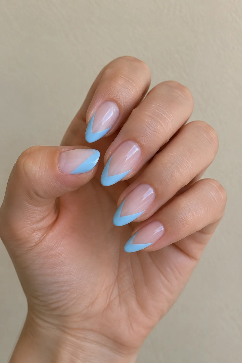 Sky blue French tips angled as a side wing design on oval nails