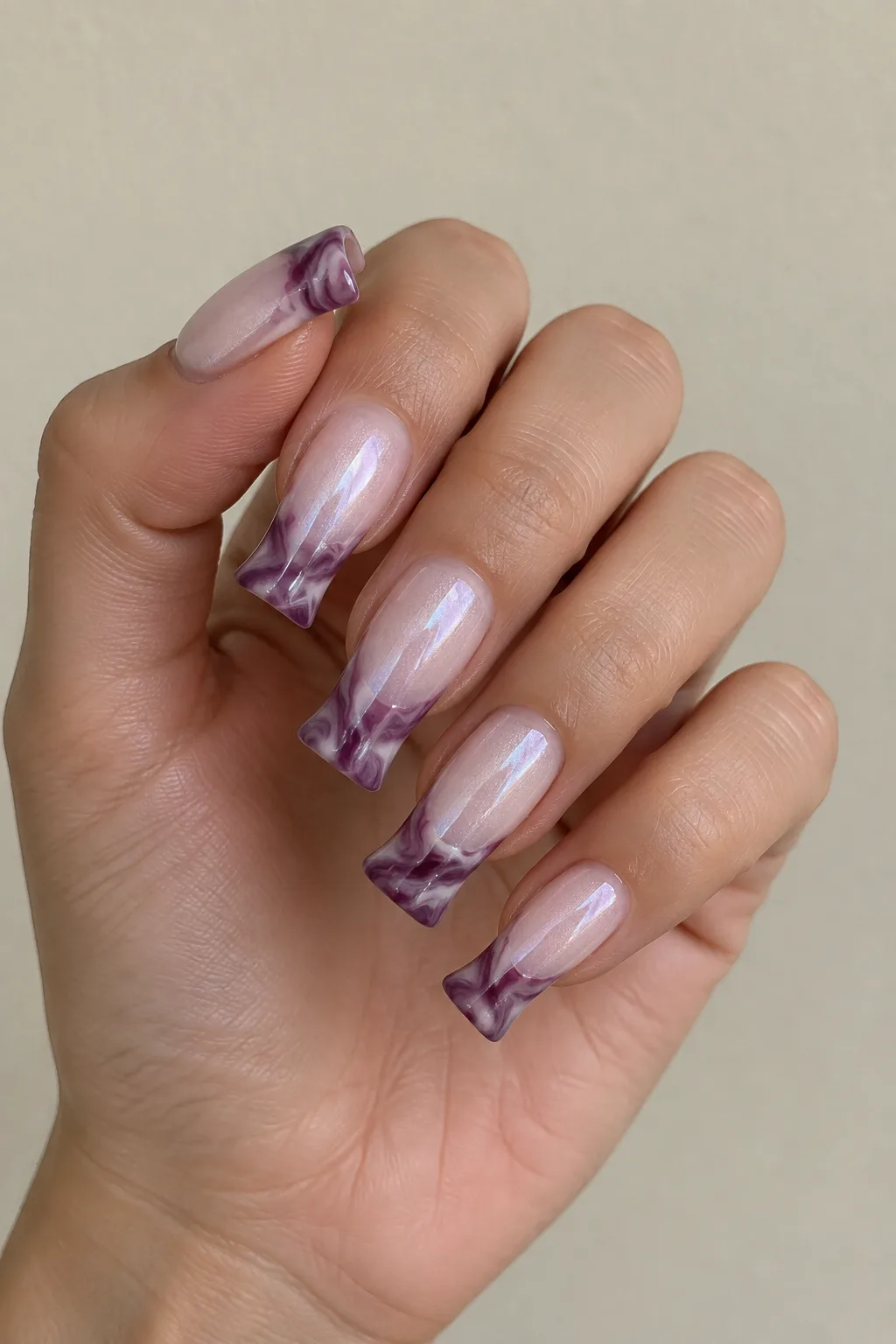 Plum marble French tips on flare shaped nails with a glossy swirl finish