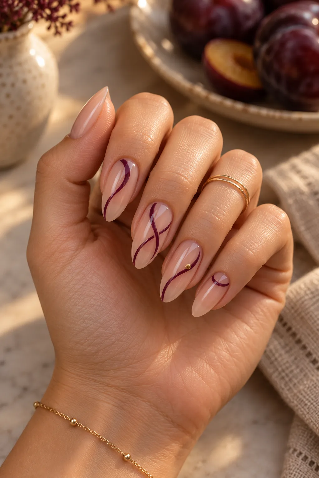 Negative space swirl dark plum nails for fall on long almond nails