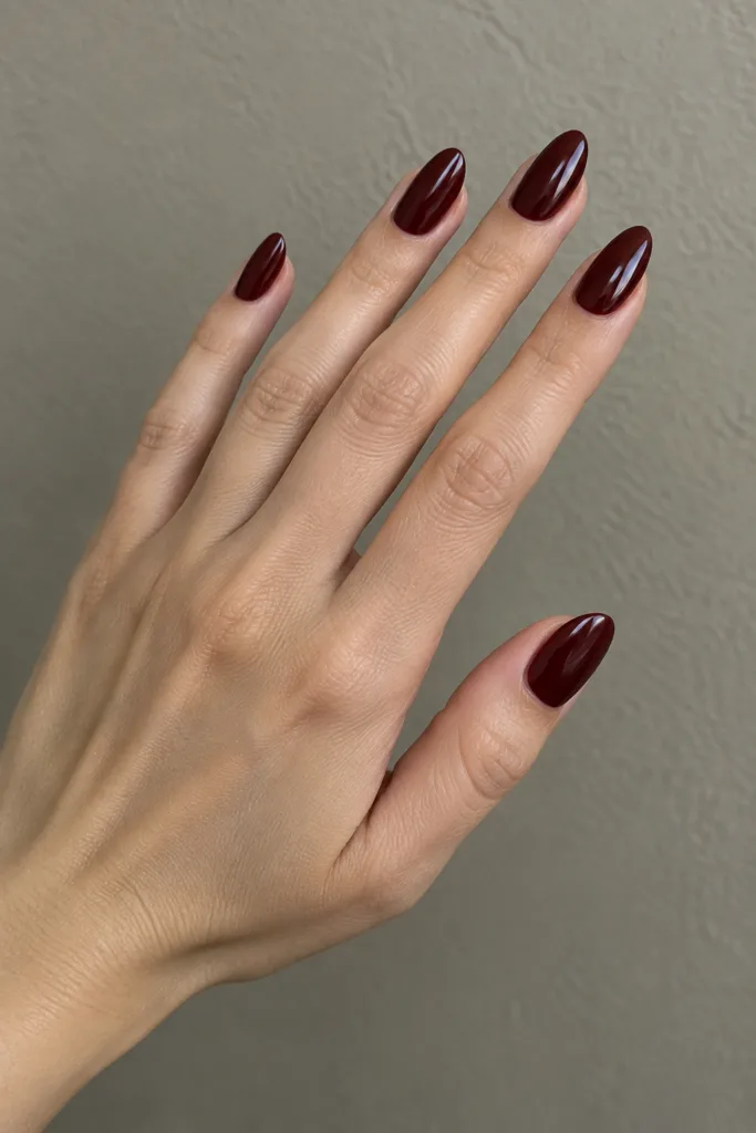 Glossy oxblood almond dark red fall nails with high shine