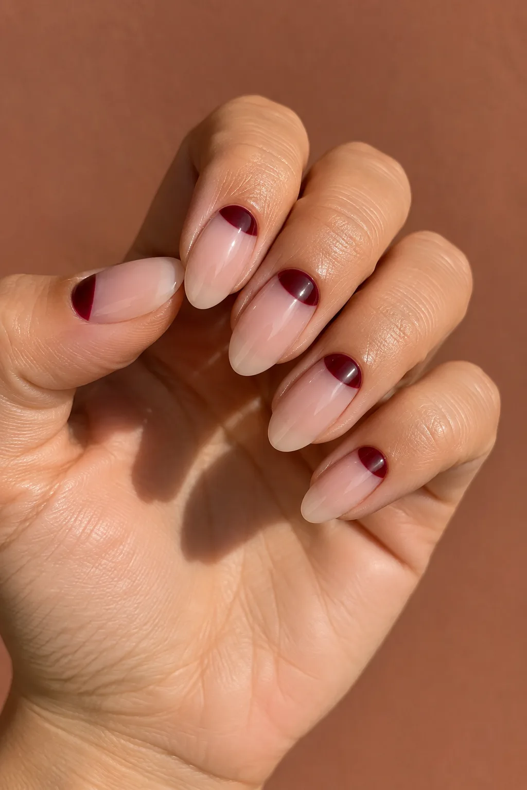 Oxblood half moon dark red fall nails on medium oval shape
