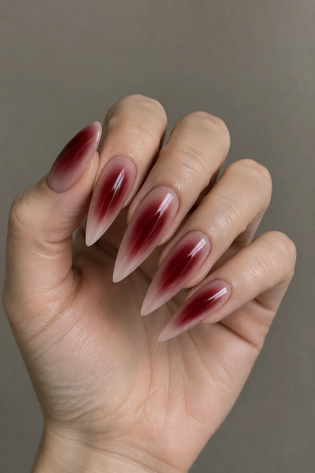 Oxblood aura glow dark red fall nails on long stiletto nails