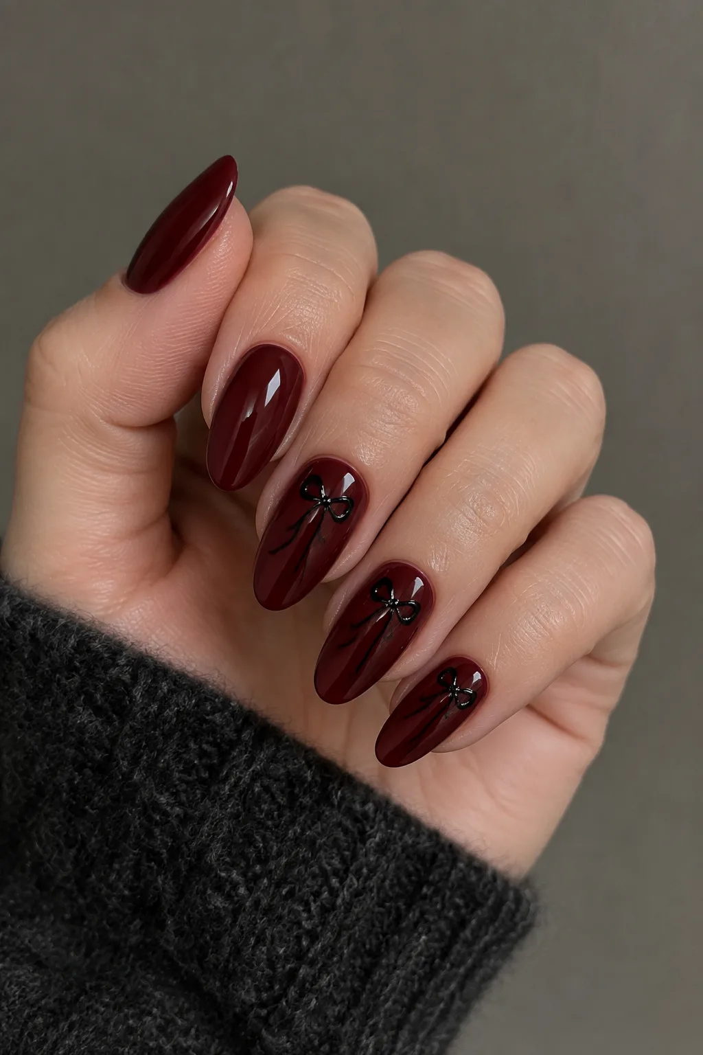 Wine nails with tiny black bows, dark red fall nails on almond