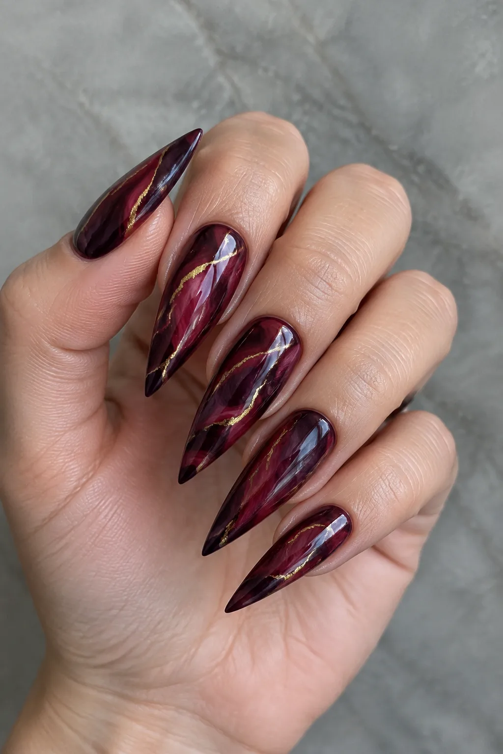Wine and gold marble dark red fall nails on long stiletto