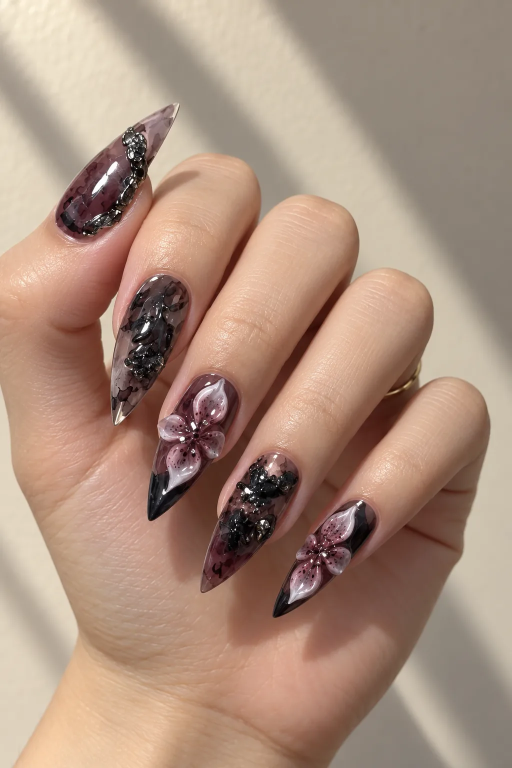 Smoky brown stiletto nails with gradient fade and 3D floral accents