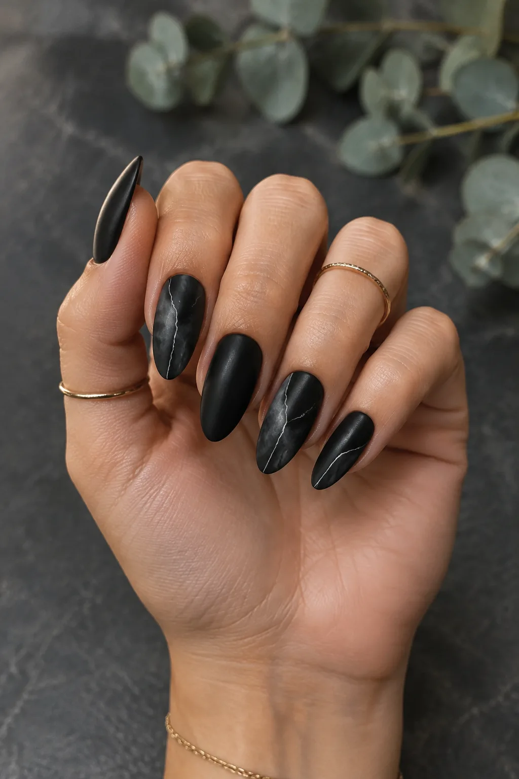 Matte black almond nails with white marble veins