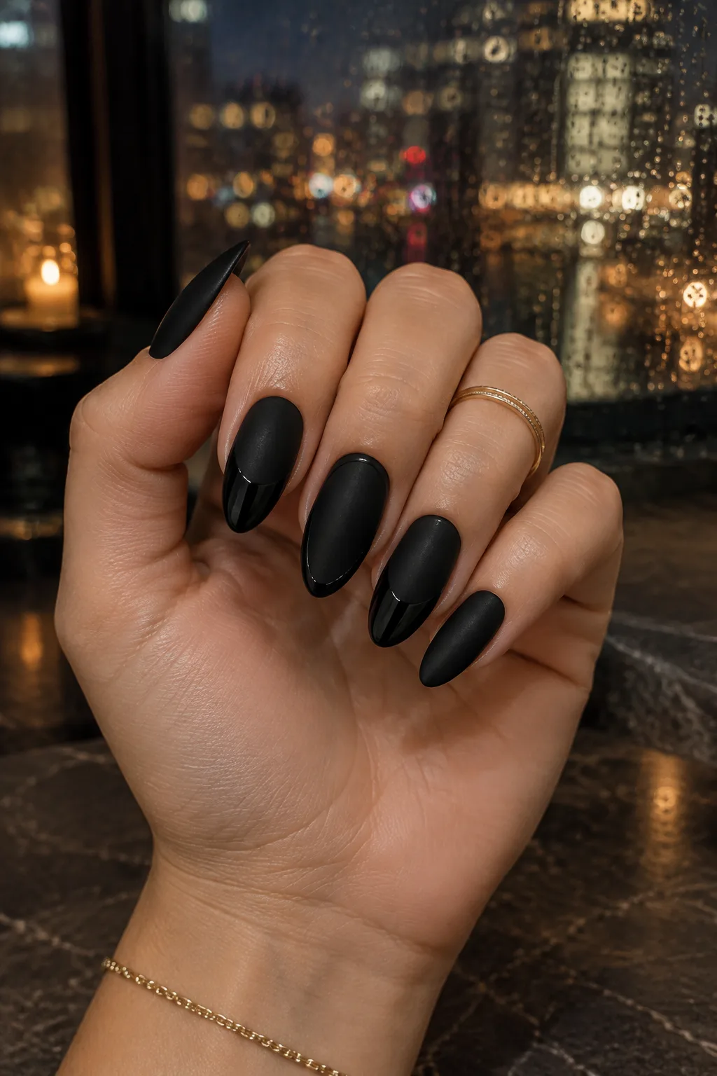 Matte black almond nails with glossy black French tips