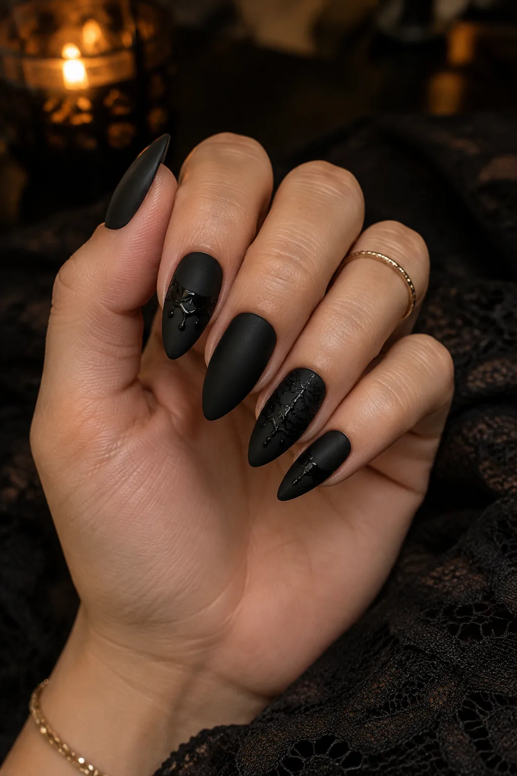 Matte black almond nails with black-on-black lace art