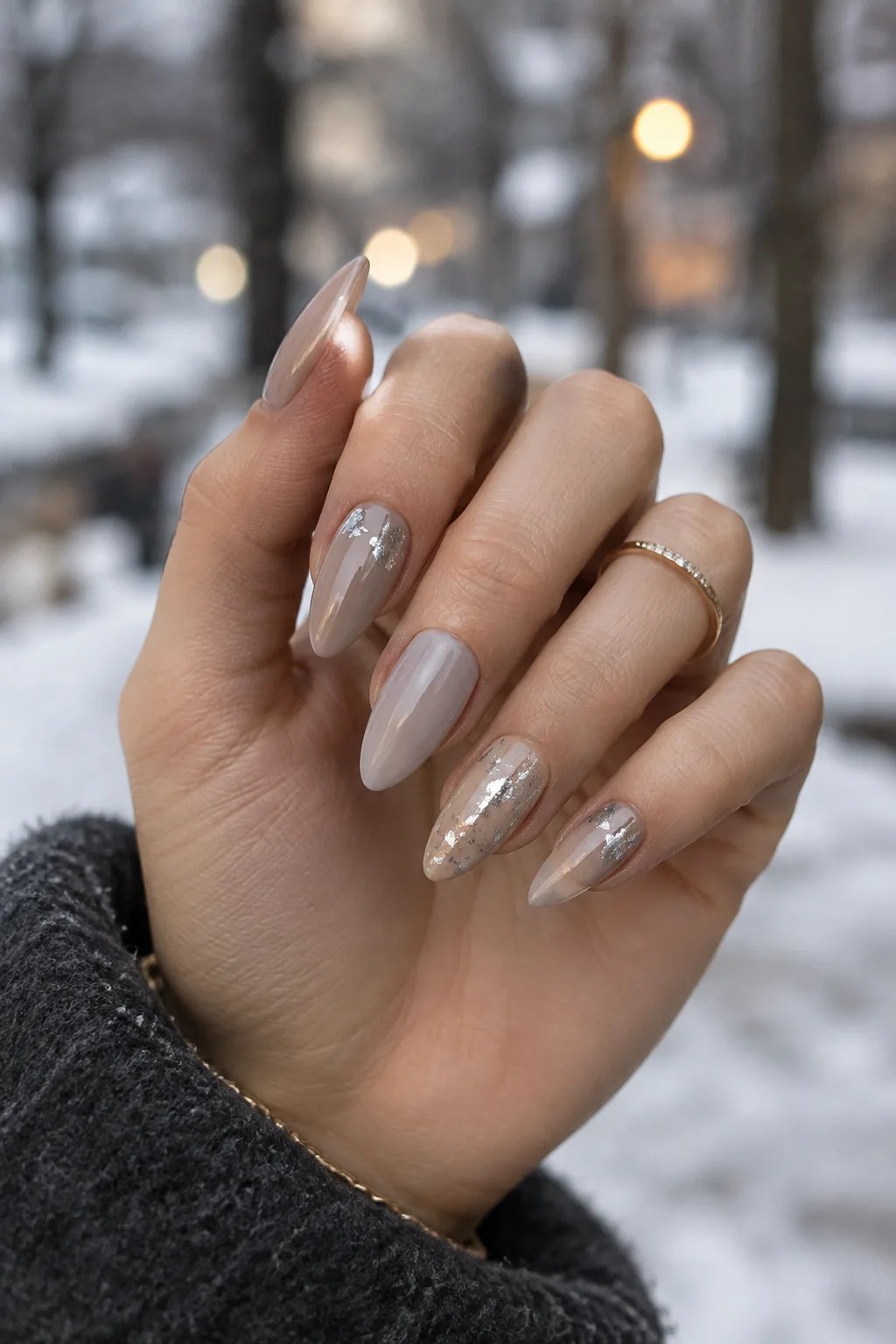 Silver leaf flecks on taupe, minimalist winter nail designs on short stiletto nails