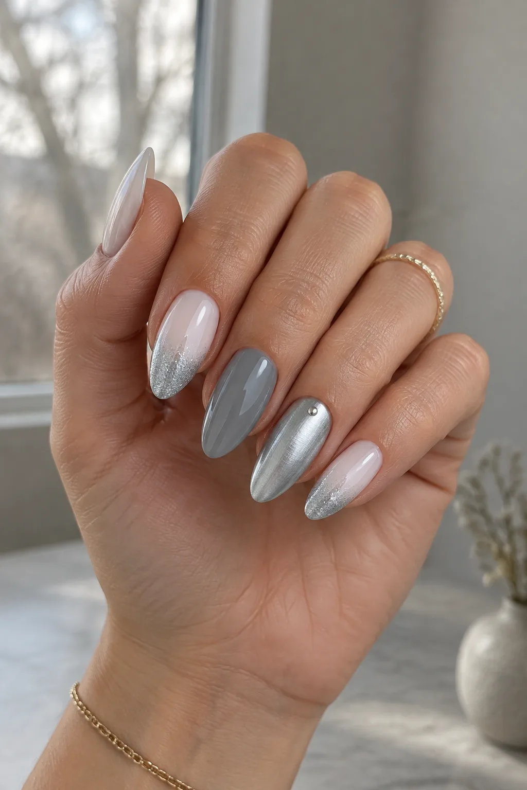 Brushed silver chrome and pewter minimalist winter nail designs on medium almond nails