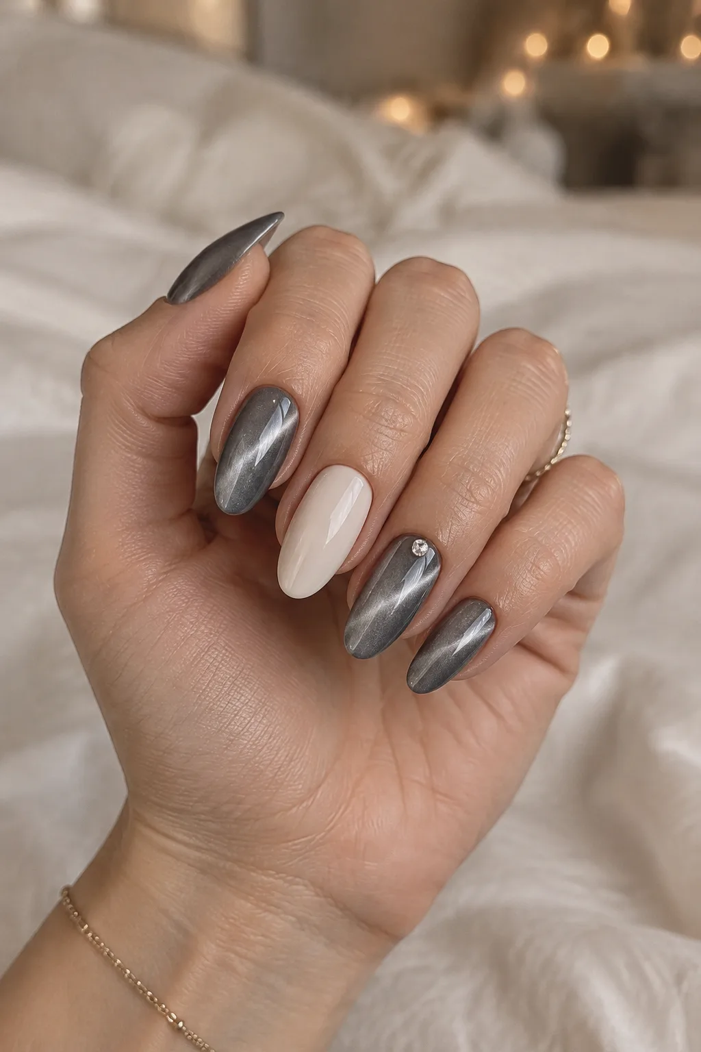Smoke grey cat-eye and milky bone minimalist winter nail designs on almond nails