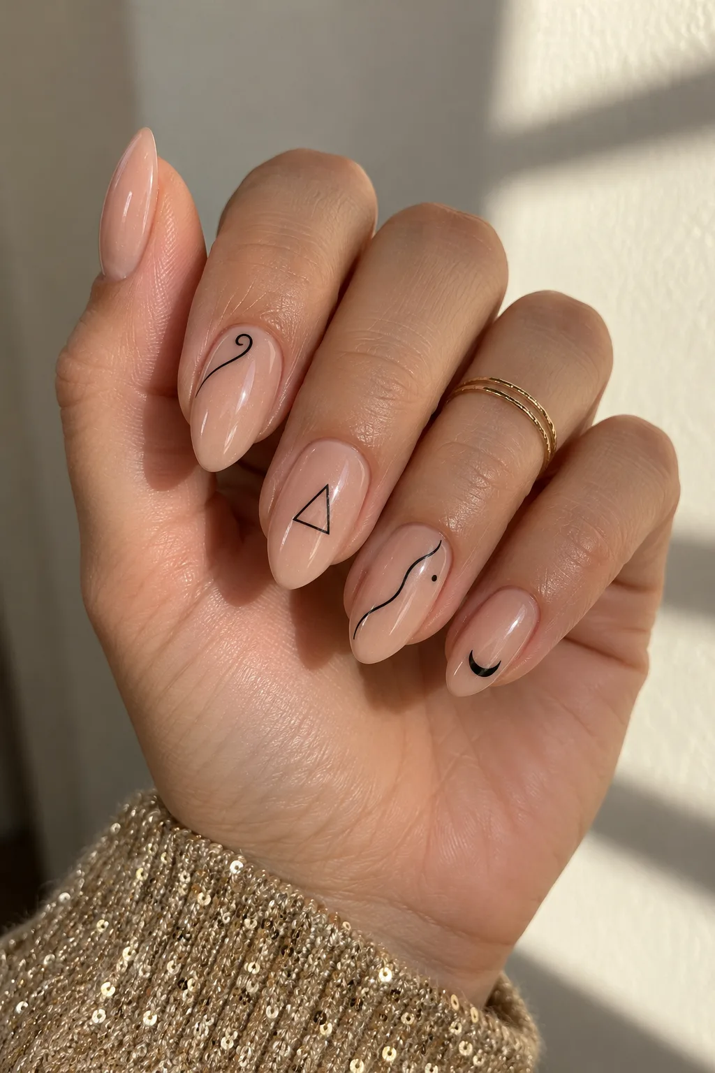 Nude nails with black line art, perfect nails to wear with a gold party dress
