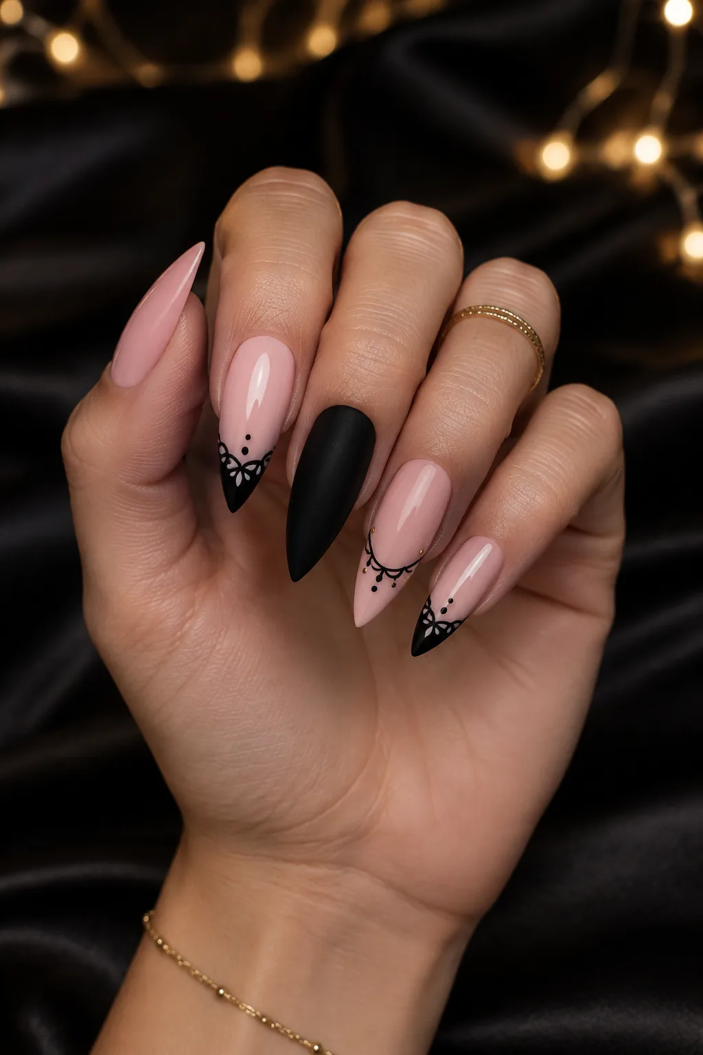 Black lace stiletto nails to wear with a gold party dress