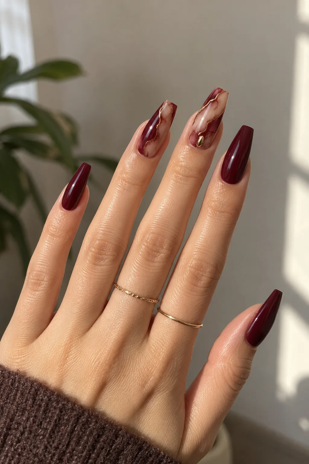 Oxblood marble nails with bronze veins, nails to wear with a red dress